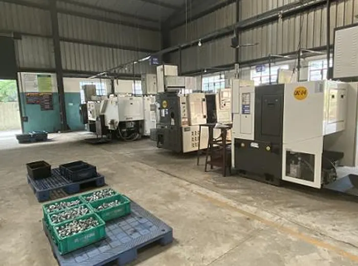 CNC cell with bins of finished components on pallets